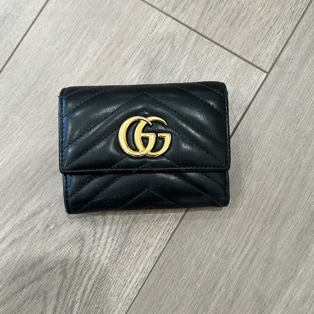 Black leather tri-fold Gucci wallet